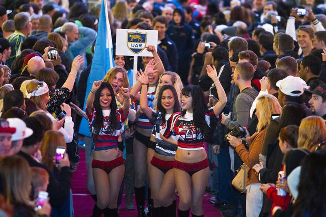 The USA Sevens cheerleaders lead a parade for the USA Sevens International Rugby Tournament players during opening ceremonies at the Fremont Street Experience on Thursday, Jan. 23, 2014.